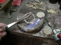 It is extremely important that the treasure coins are not damaged in any way during the jewelry setting process