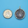 Pendant size next to a Quarter