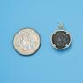 Pendant size next to a Quarter