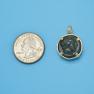 Pendant size next to a Quarter
