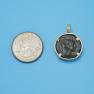 Pendant size next to a Quarter