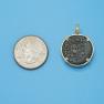 Pendant size next to a Quarter