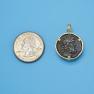 Pendant size next to a Quarter