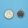 Pendant size next to a Quarter