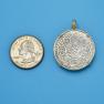 Pendant size next to a Quarter