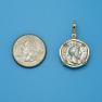 Pendant size next to a Quarter