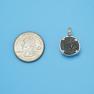 Pendant size next to a Quarter