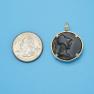 Pendant size next to a Quarter