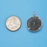 Pendant size next to a Quarter