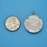 Pendant size next to a Quarter
