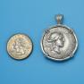 Pendant size next to a Quarter