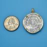 Pendant size next to a Quarter