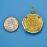Pendant size next to a Quarter
