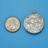Pendant size next to a Quarter