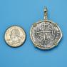 Pendant size next to a Quarter