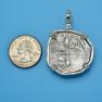 Pendant size next to a Quarter