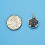 Pendant size next to a Quarter