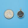Pendant size next to a Quarter