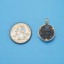 Pendant size next to a Quarter