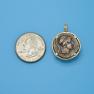 Pendant size next to a Quarter