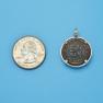 Pendant size next to a Quarter