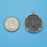 Pendant size next to a Quarter