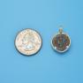 Pendant size next to a Quarter