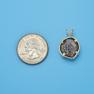 Pendant size next to a Quarter