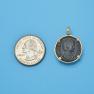 Pendant size next to a Quarter