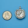 Pendant size next to a Quarter
