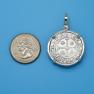 Pendant size next to a Quarter