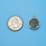 Pendant size next to a Quarter