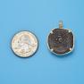 Pendant size next to a Quarter