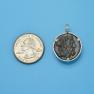 Pendant size next to a Quarter