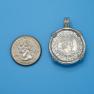 Pendant size next to a Quarter