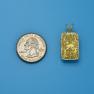 Pendant size next to a Quarter