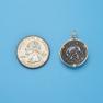 Pendant size next to a Quarter