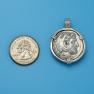 Pendant size next to a Quarter