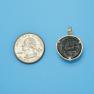 Pendant size next to a Quarter