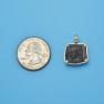 Pendant size next to a Quarter