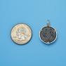 Pendant size next to a Quarter