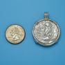 Pendant size next to a Quarter