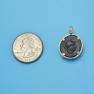 Pendant size next to a Quarter