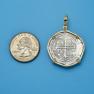 Pendant size next to a Quarter
