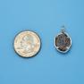 Pendant size next to a Quarter