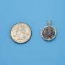 Pendant size next to a Quarter