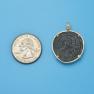 Pendant size next to a Quarter