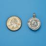 Pendant size next to a Quarter