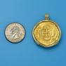 Pendant size next to a Quarter