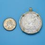 Pendant size next to a Quarter